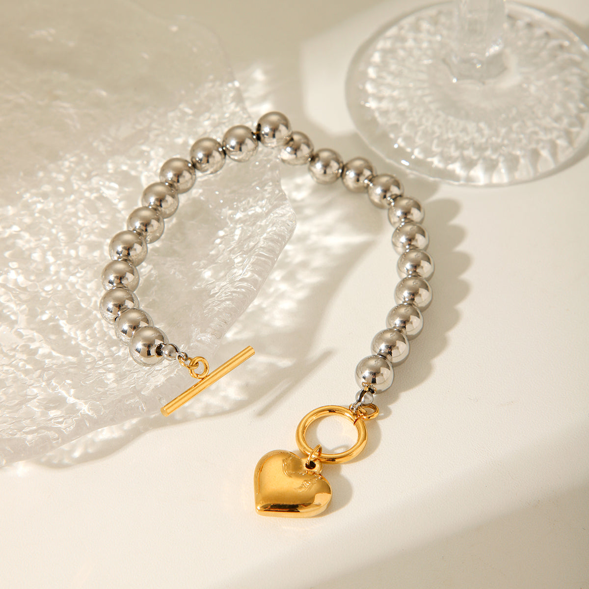 BRACCIALE SFERE LUMINOSE IN ARGENTO CON PENDOLO A CUORE IN ORO ACCIAIO INOX 304 MIS.20,5 CM