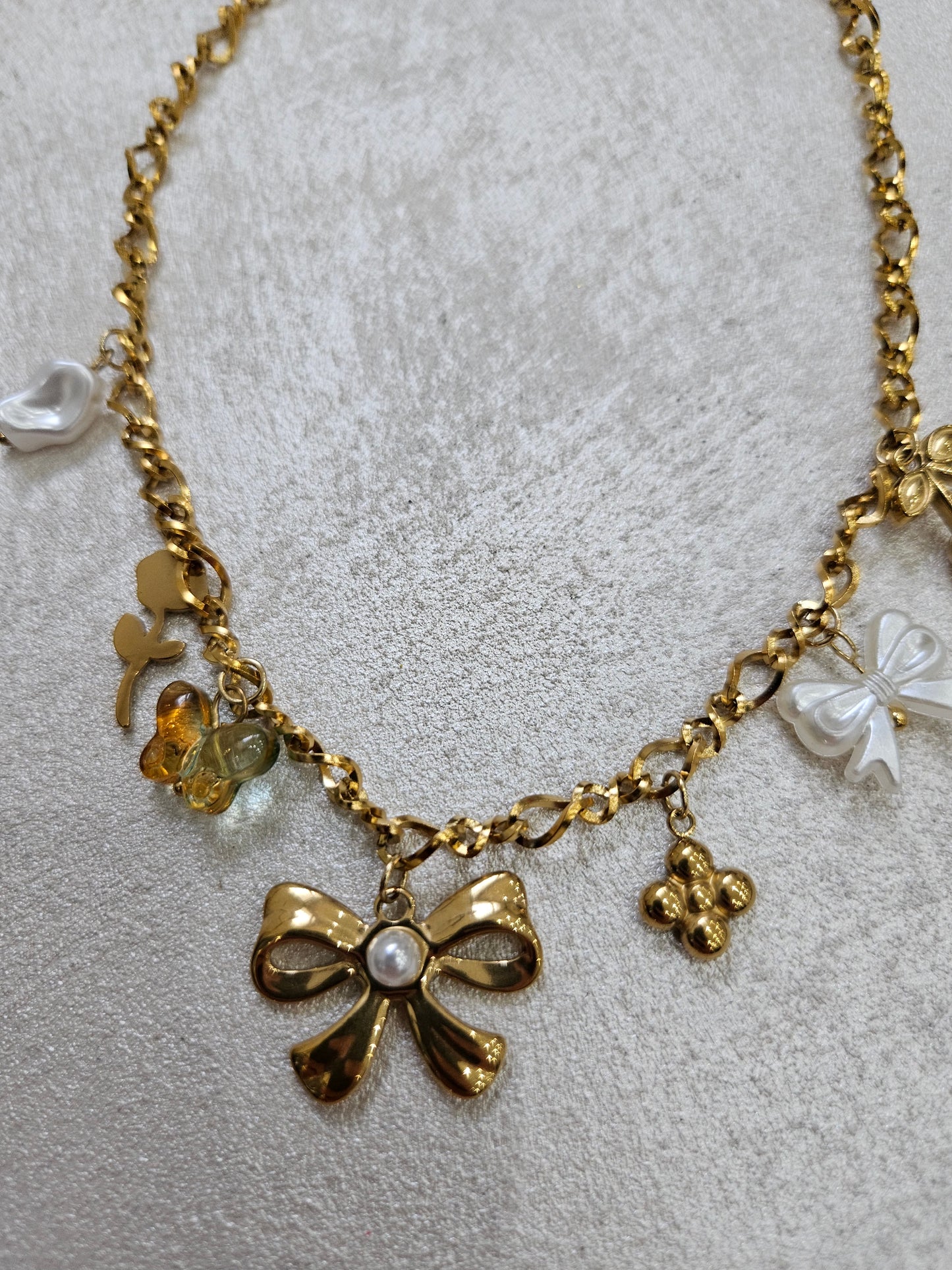 Collana fiocco con charm in acciaio inox