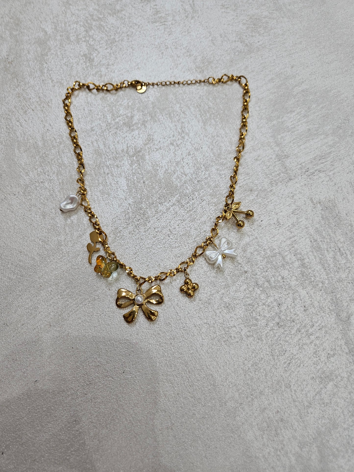Collana fiocco con charm in acciaio inox